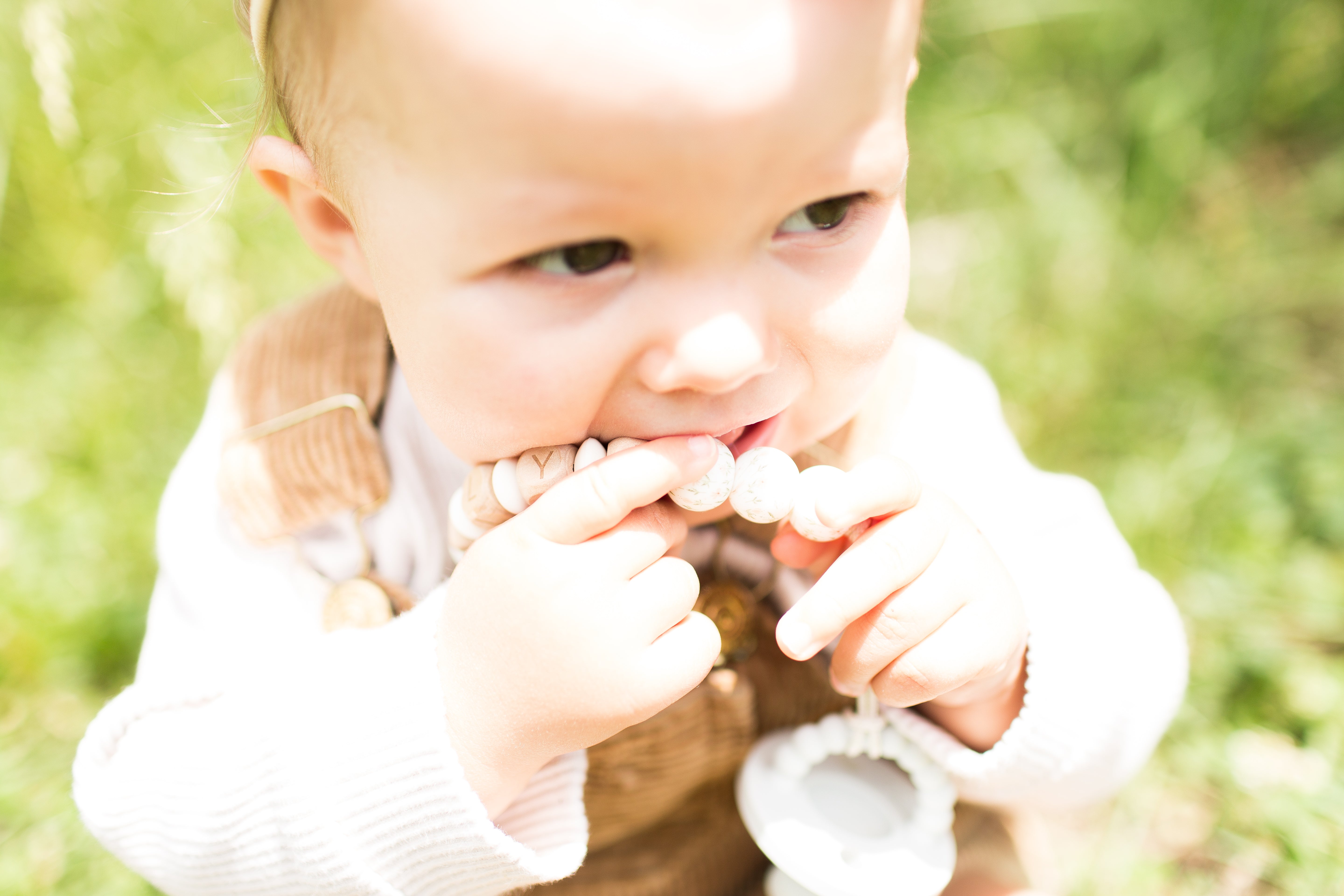 Personalized flower-themed pacifier clip designed to keep pacifiers clean.