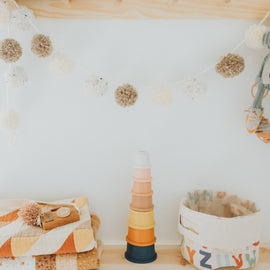 silicone stacking cups set in pastel colors arranged in a tower