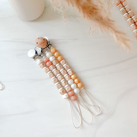Metallic white, rose gold, and gold silicone name pacifier clips.