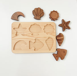wooden sea creatures puzzle made from natural linden wood on white background. 